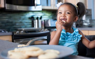 Little girl eating a cookie