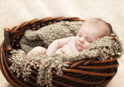 Sleeping Newborn Baby in Basket