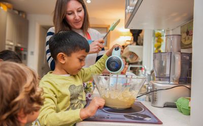 女人在厨房用搅拌机帮孩子们