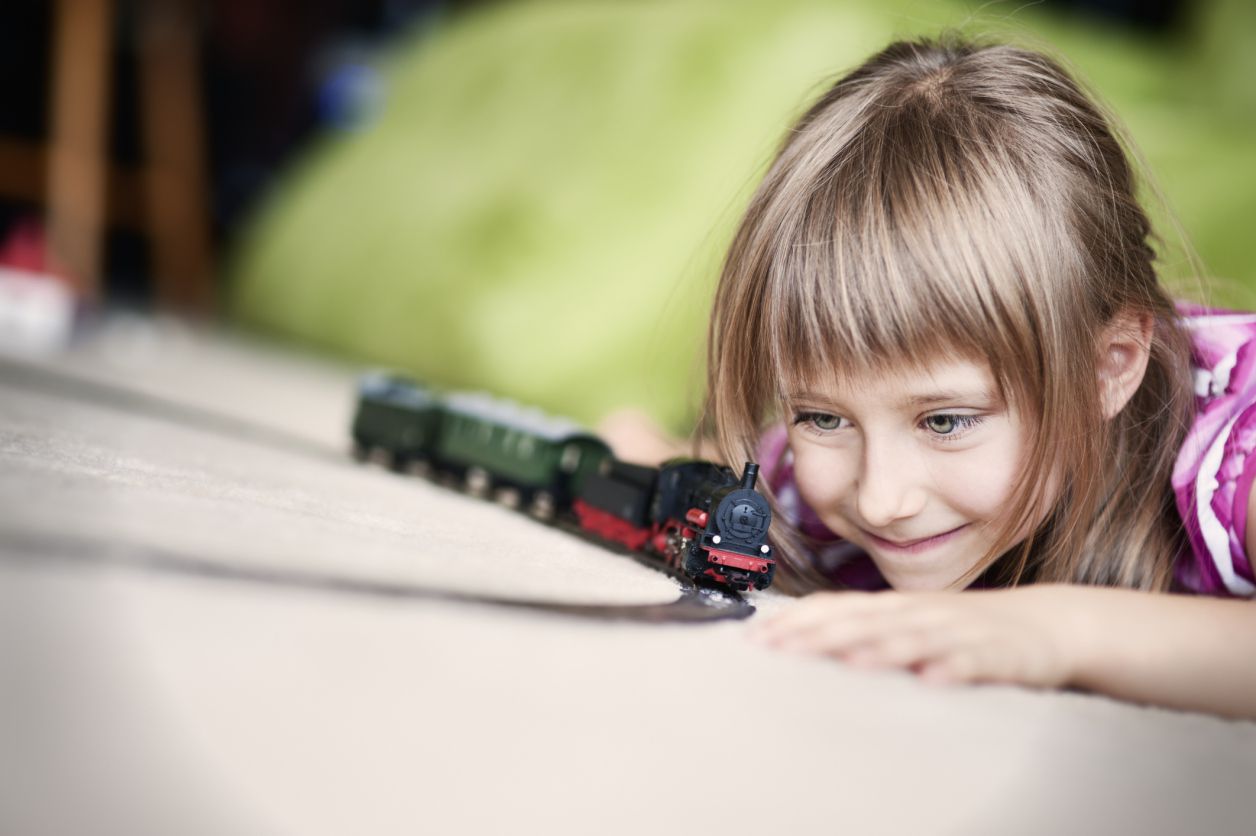 Girl playing with a train