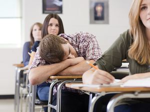 Male high school student asleep in class