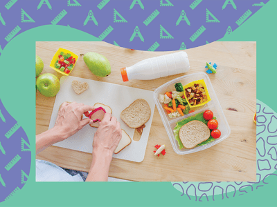 Overhead view of hands making a packed lunch