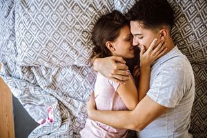 Couple in bed embracing