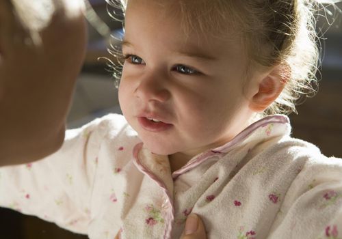 Mother talking to 3 year old daughter.