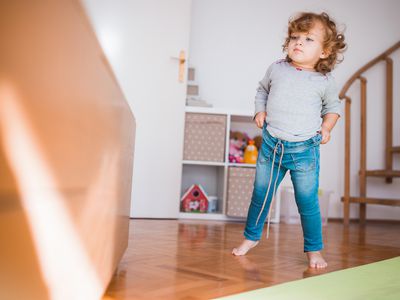 Toddler pulling up their own pants