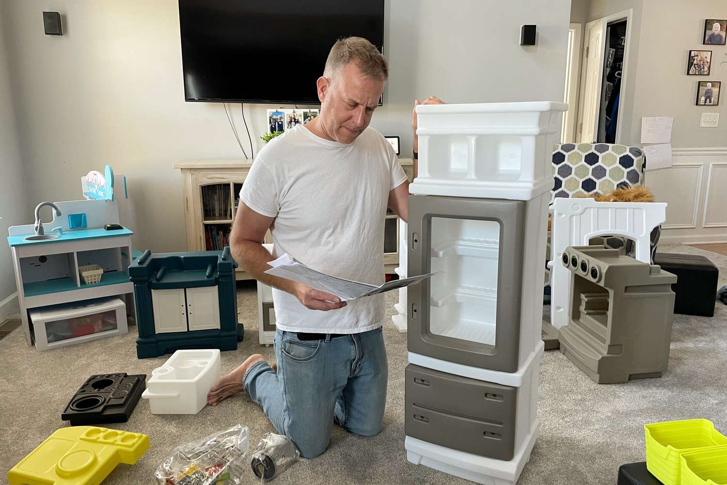 Person assembling parts of Step2 Elegant Edge Kitchen