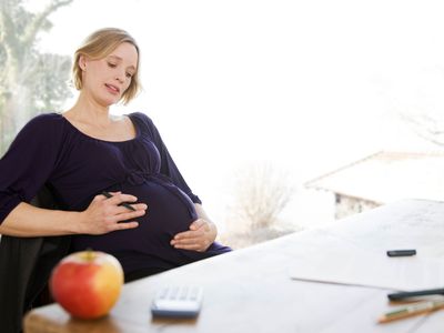 pregnant woman working in home office