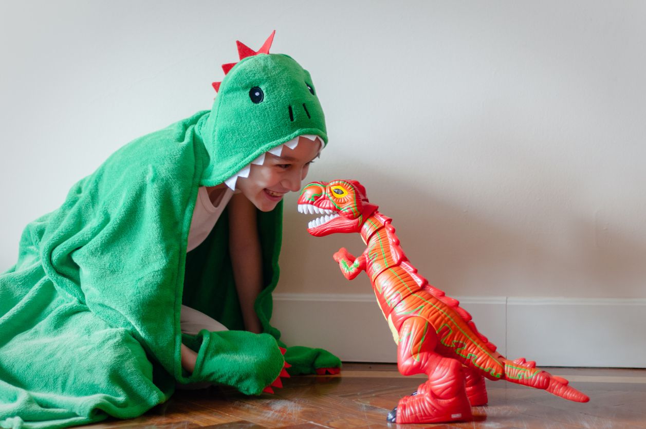 child in a dinosaur costume