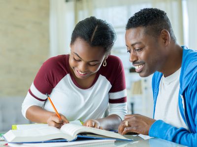 Confident dad helps daughter with homework