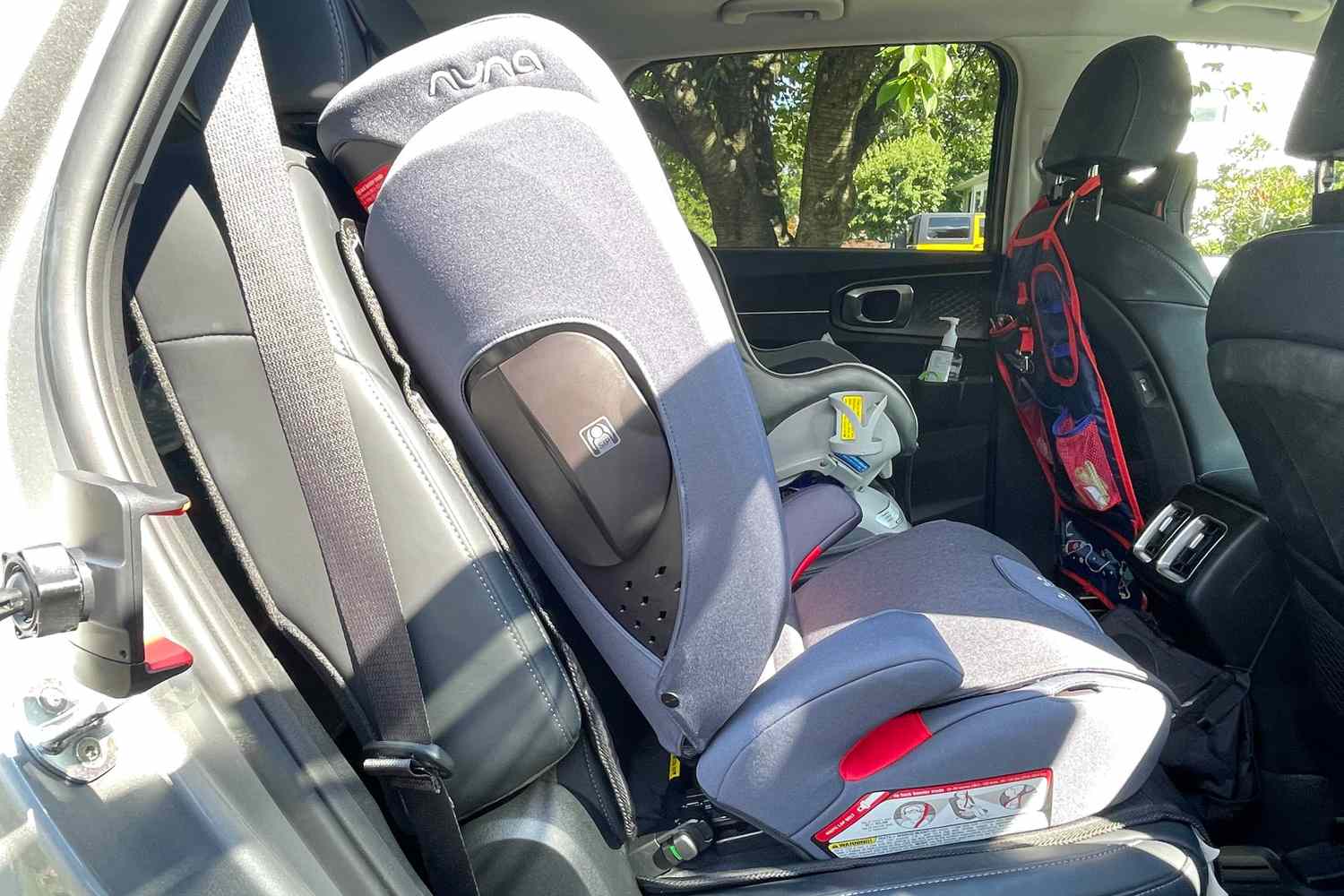 The Nuna AACE Booster Seat installed in the backseat of a car