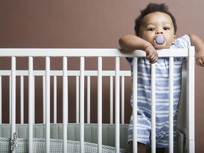 baby boy standing in a cot