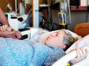 Young woman enduring labor pains in hospital.