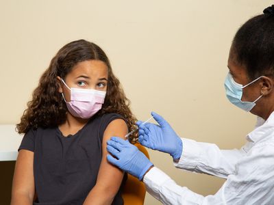 Preteen girl gets COVID-19 vaccine