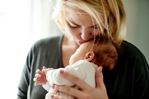 Mother kissing baby