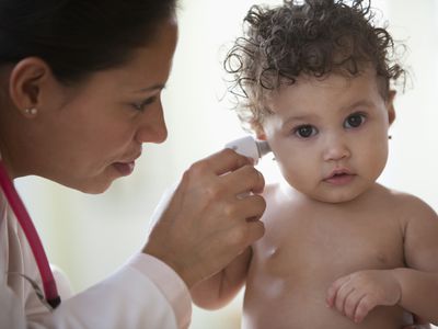 healthcare provider checking baby's temperature