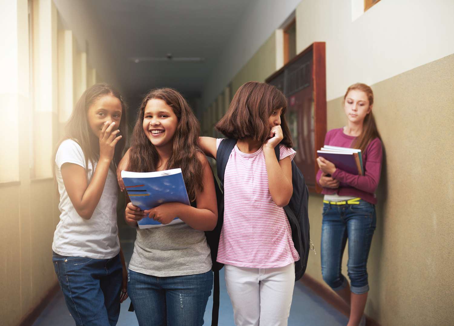 group of girls talking and laughing about other girl