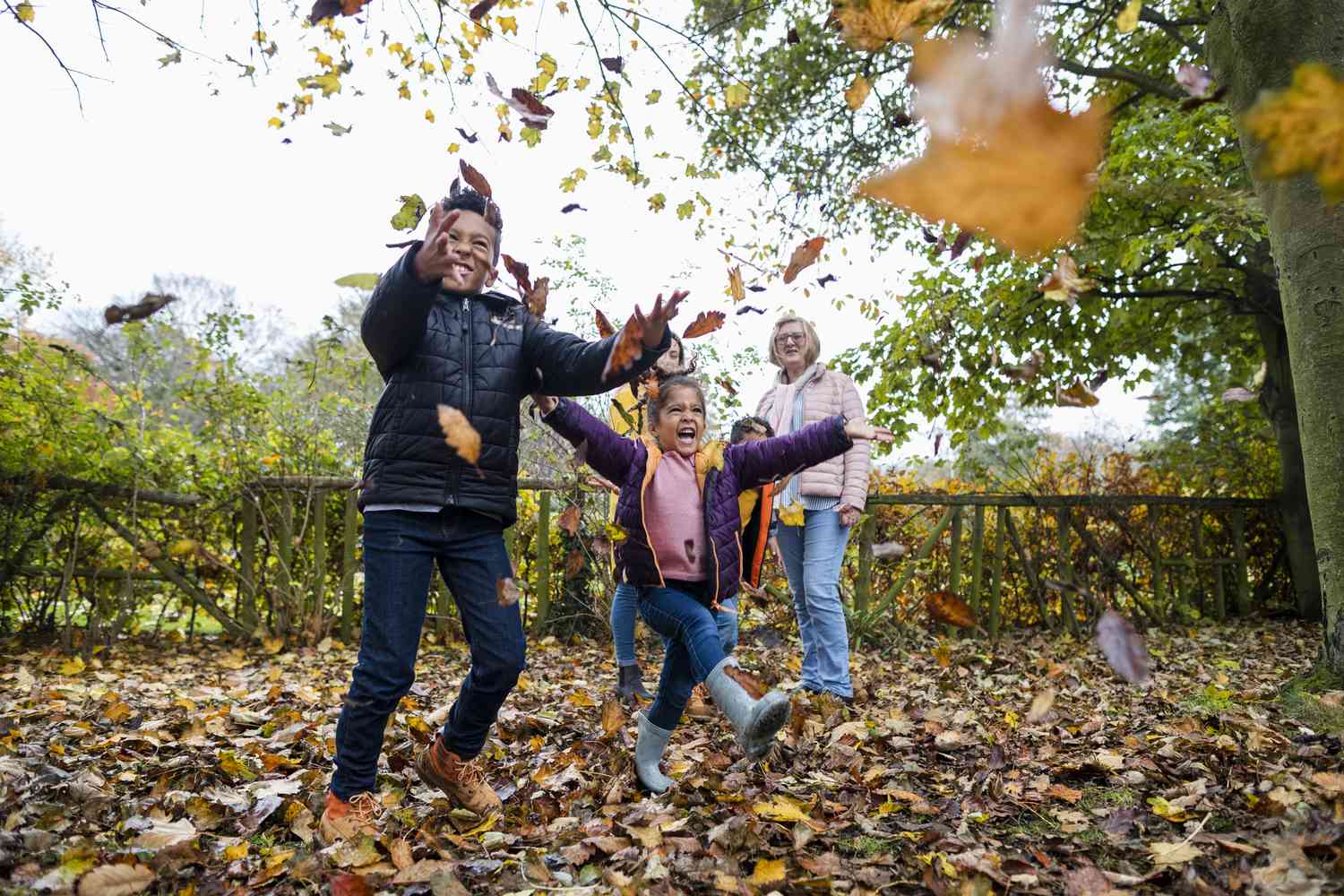 Kids Playing in a leaf pile