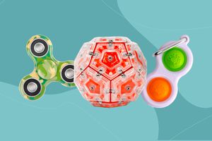 A variety of fidget toys on a green background