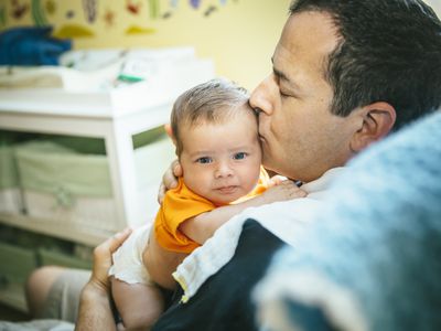 Father kissing baby on head