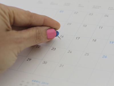 Close-up of hand pinning on Calendar Folder