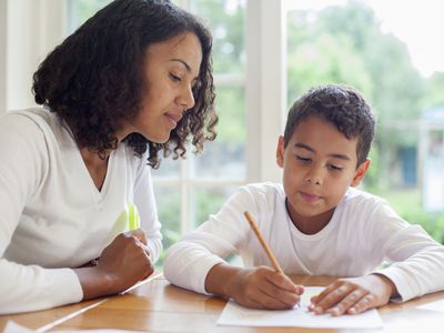 Mother and child writing on paper