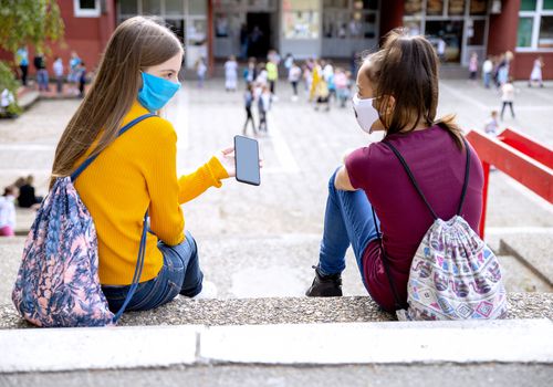 two middle school girls talking outside