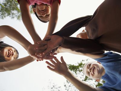 Four children grasping hands.