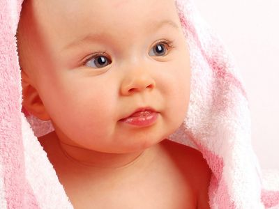 Baby girl with pink towel