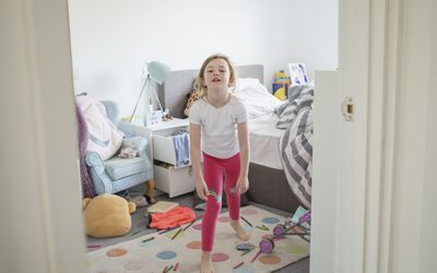 Young girl having tantrum in bedroom