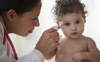 healthcare provider checking baby's temperature