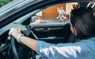 Mother dropping child off at father's house