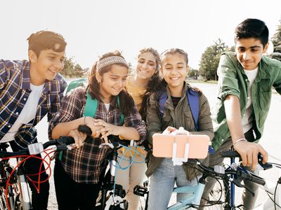 A group of middle school aged kids bike to school