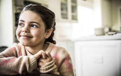 Little girl smiling indoors