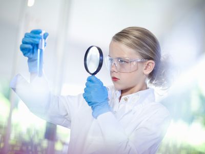 Curious little girl pretending to be a scientist