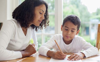 Mother and child writing on paper