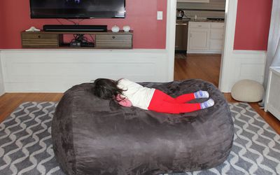 three post bean bag chair with child laying down