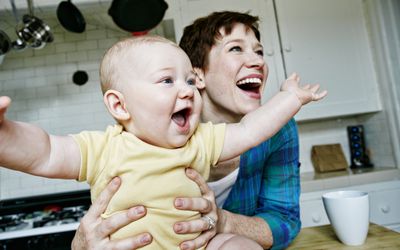 Mom and baby with arms spread open.