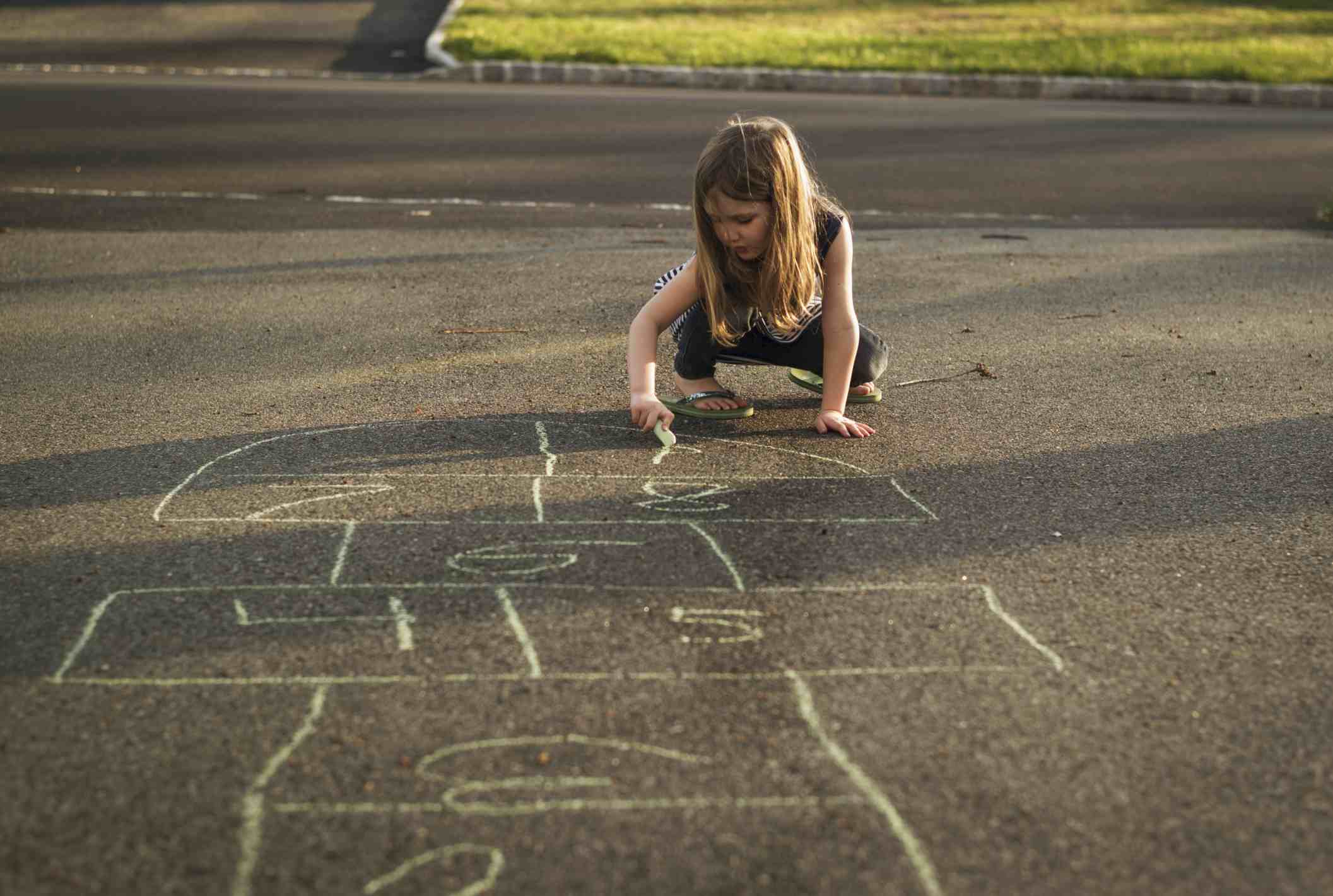 Girl drawing Hopscotch board