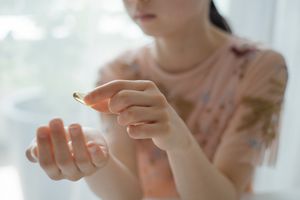 Girl ready taking a supplement capsule - stock photo