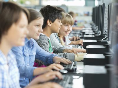 a row of children using computers