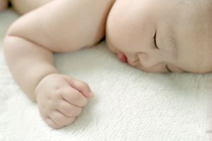 Baby girl sleeping on bed