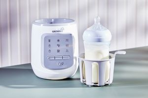 baby bottle with milk in a bottle warmer