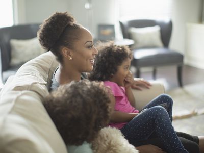 parent and two kids watching TV