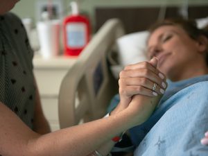 Woman in labor in hospital bed.