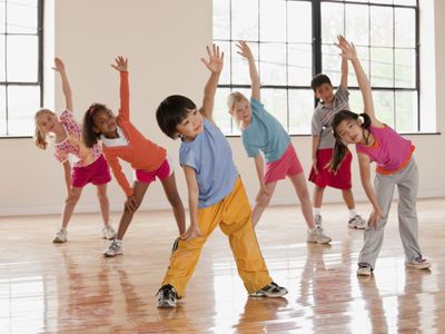 a group of six kids performing dynamic stretches