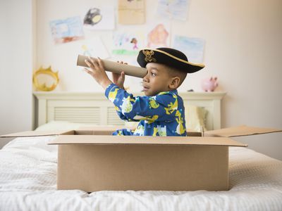 Little boy playing with cardboard box