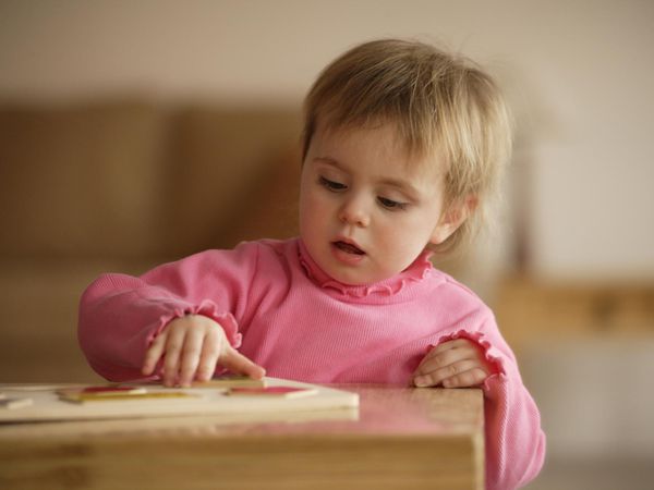 Young girl doing a puzzle