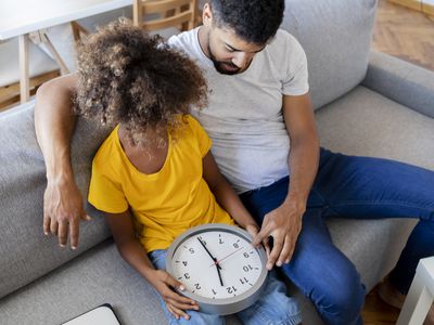 Dad teaching daughter to tell time