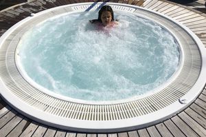 Young girl relaxing in jacuzzi