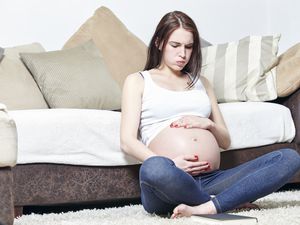 A pregnant woman experiencing braxton hicks contractions.